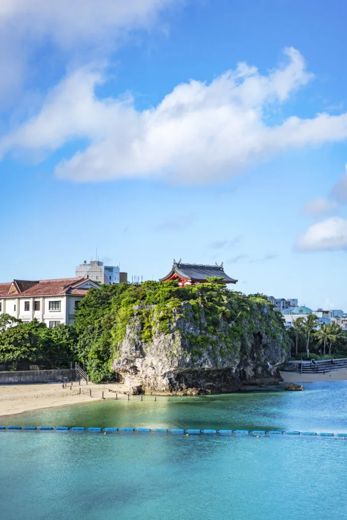 Summer landscape of the Shinto Shrine Naminoue at the top of a cliff overlooking the beach and ocean of Naha in Okinawa Prefecture, Japan